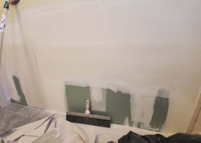 new bathroom drywall being sanded and primed by mckeague drywall in hawaii