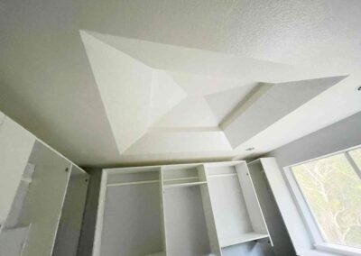 photo showing a second floor room with a newly finished octagon shaped ceiling with recessed lighting and painted walls and cupboards and dressers that were completed by Mckeague Drywall in mililani oahu hawaii