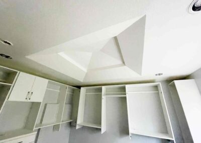 photo showing a second floor room with a newly finished octagon shaped ceiling with recessed lighting and painted walls and cupboards and dressers that were completed by Mckeague Drywall in mililani oahu hawaii