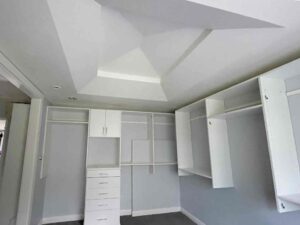 photo showing a second floor room with a newly finished octagon shaped ceiling with recessed lighting and painted walls and cupboards and dressers that were completed by Mckeague Drywall in mililani oahu hawaii
