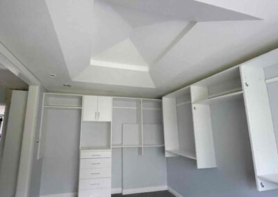 photo showing a second floor room with a newly finished octagon shaped ceiling with recessed lighting and painted walls and cupboards and dressers that were completed by Mckeague Drywall in mililani oahu hawaii