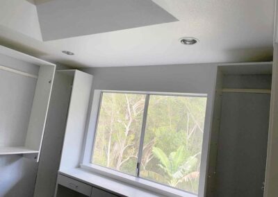 photo showing a second floor room with a newly finished octagon shaped ceiling with recessed lighting and painted walls and cupboards that was finished by Mckeague Drywall in mililani oahu hawaii