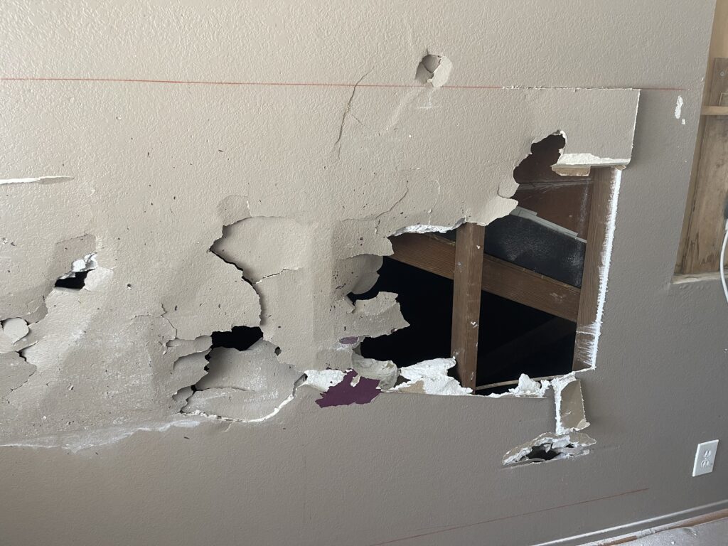 photo showing how Mckeague Drywall LLC repairs damaged drywall by removing the marked sections with a saw or knife