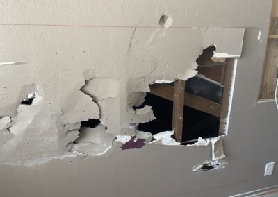 photo showing how Mckeague Drywall LLC repairs damaged drywall by removing the marked sections with a saw or knife