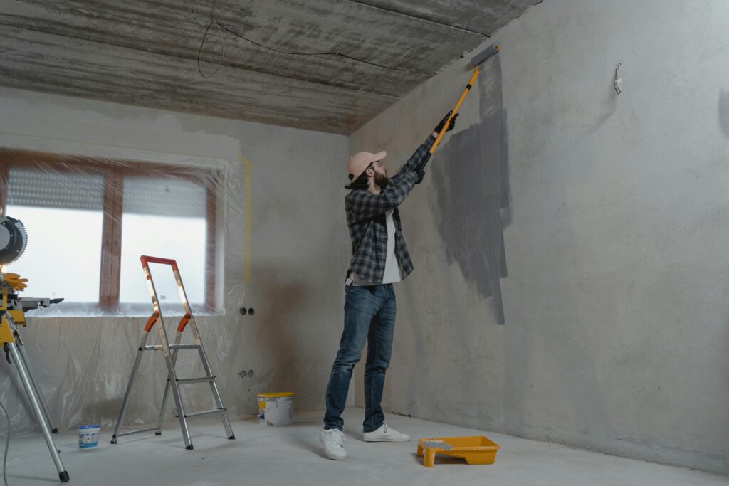 Man doing DIY paint job on his wall.